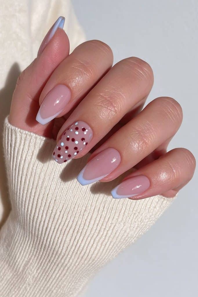 Sheer beige coffin nails with a dotted accent nail