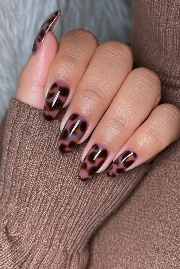 Espresso tortoiseshell almond nails with caramel and amber layers