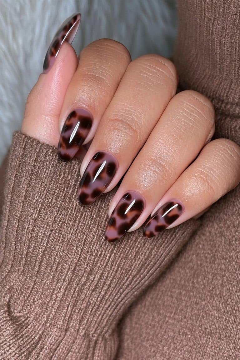 Espresso tortoiseshell almond nails with caramel and amber layers