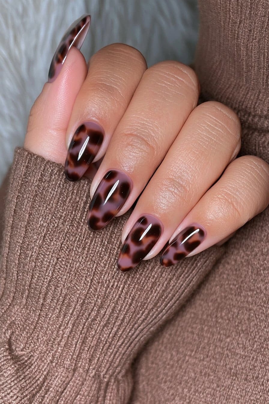 Espresso tortoiseshell almond nails with caramel and amber layers