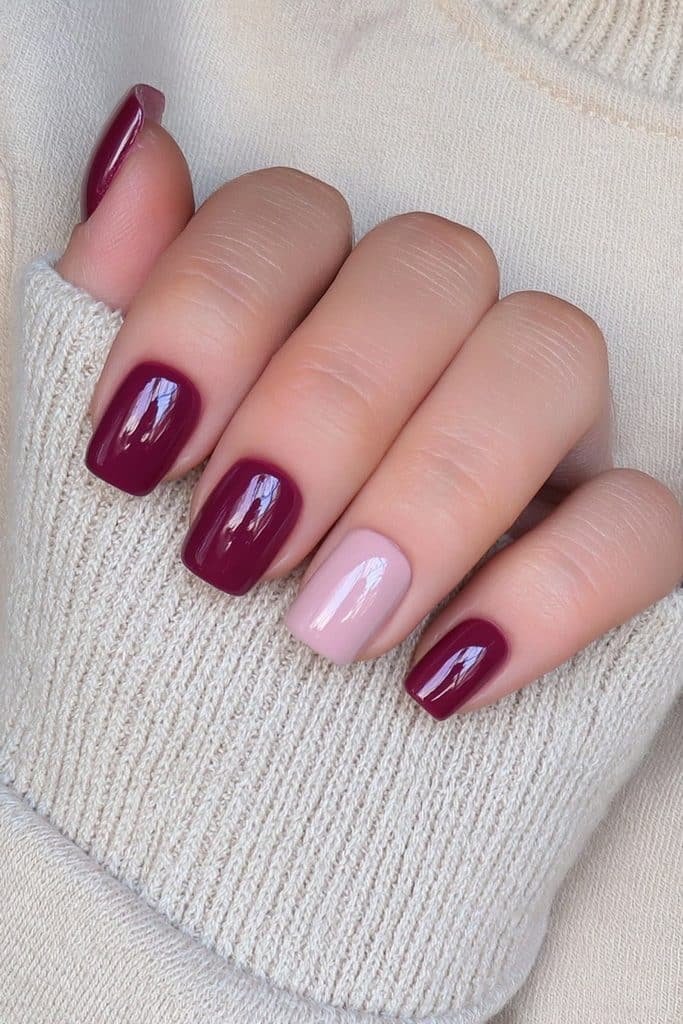 Cranberry nails paired with soft neutral shades