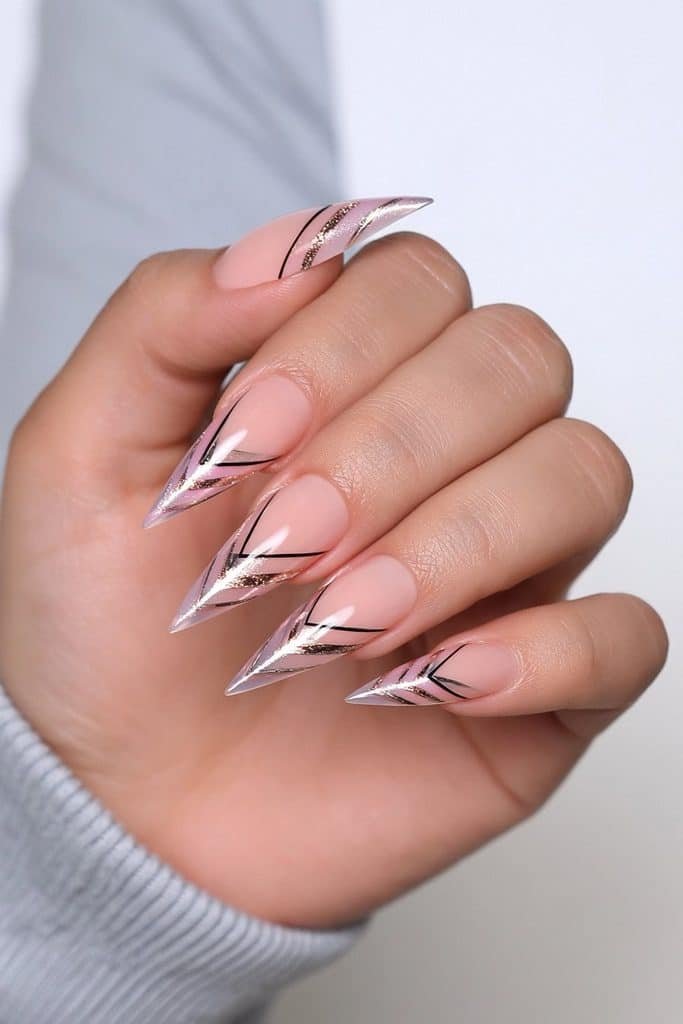 Nude stiletto nails with black and gold geometric lines