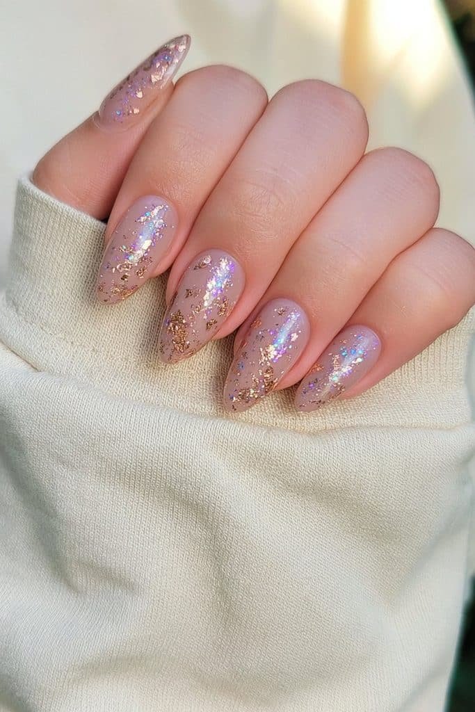 Sheer nude nails with delicate gold foil flakes