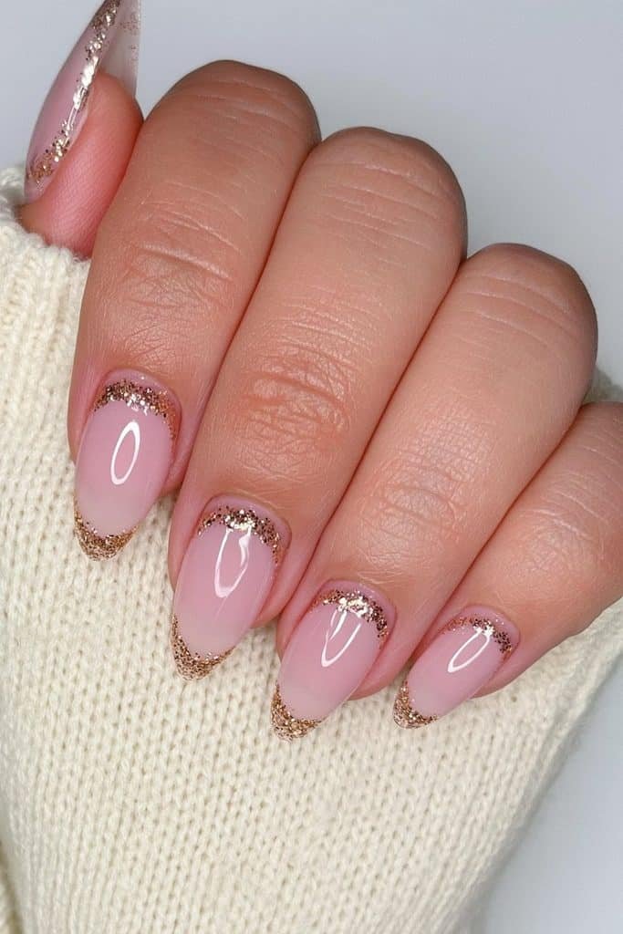 Nude nails with delicate gold glitter cuticle cuffs