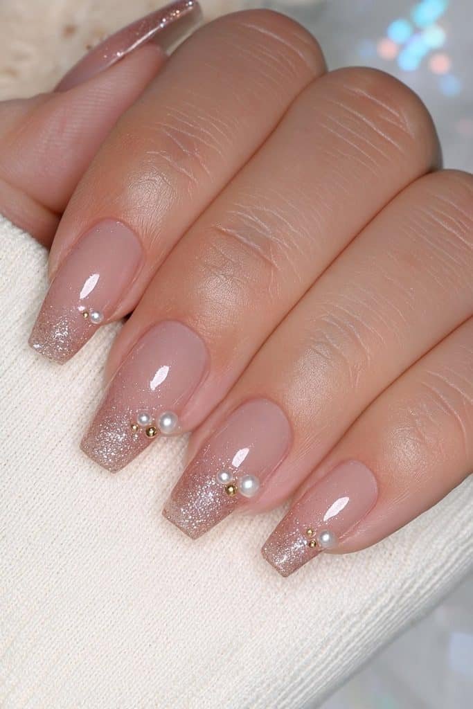 Gold glitter nails with delicate pearls and micro-beads