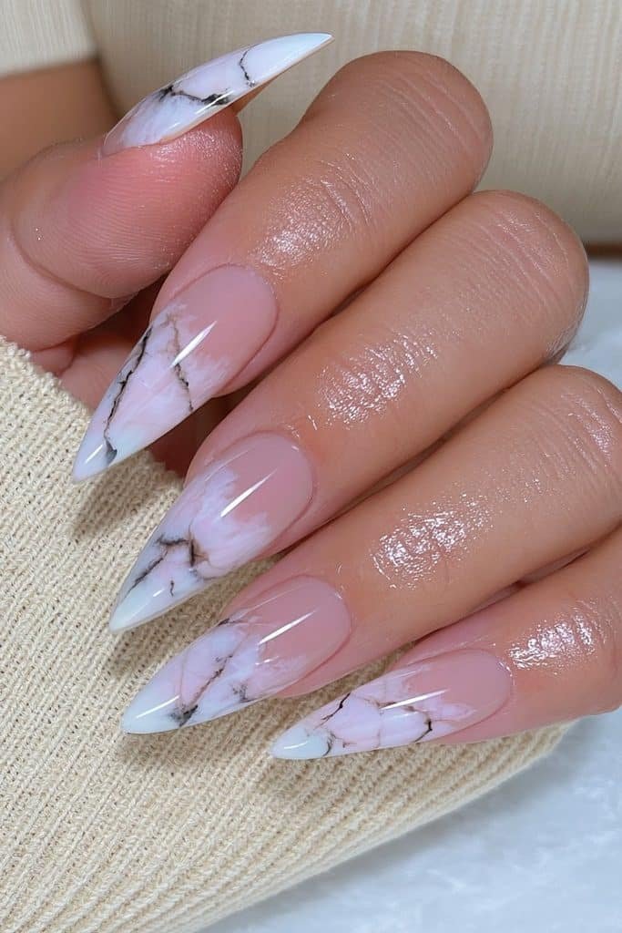 Milky white marble stiletto nails with taupe veining