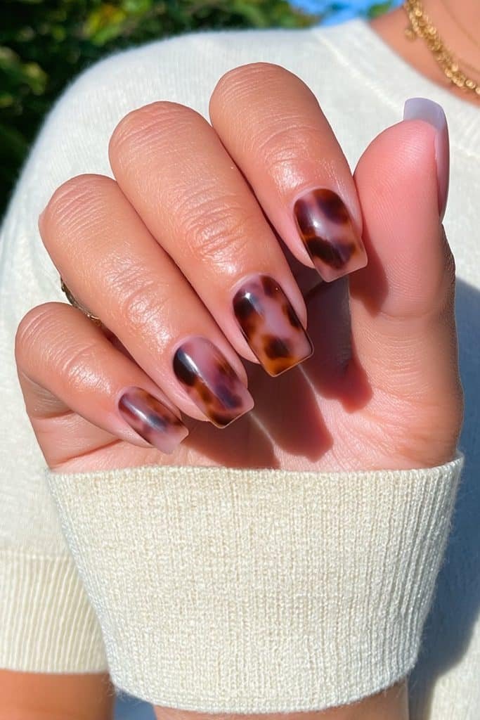 Matte tortoiseshell nails with amber caramel and brown tones