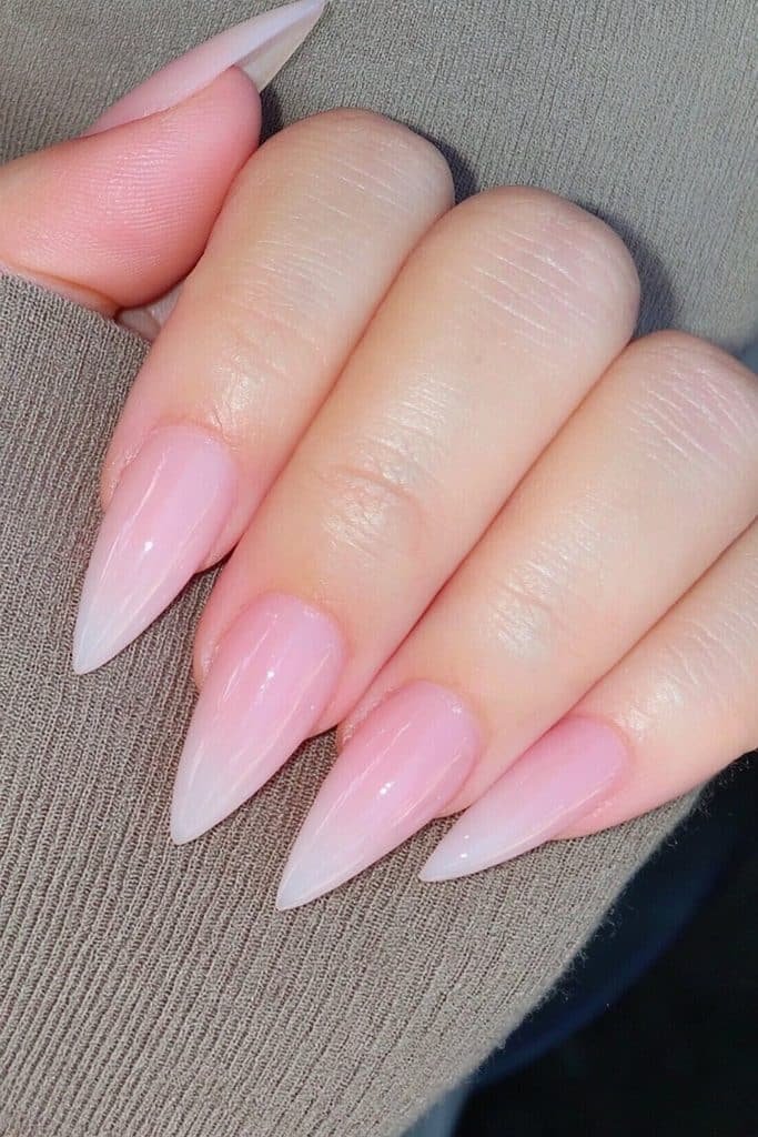 Medium beige-pink stiletto nails with glossy finish