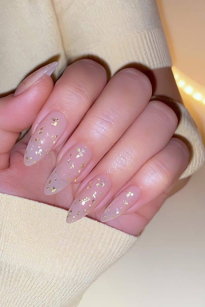 Milky nude nails with delicate gold glitter confetti