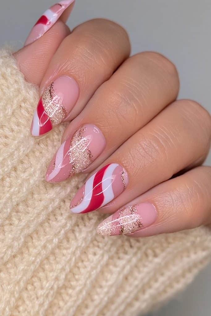 Red and white candy cane nails with delicate gold accents