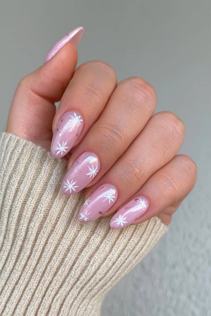 Blush nude nails with rose-gold shimmer and snowflakes