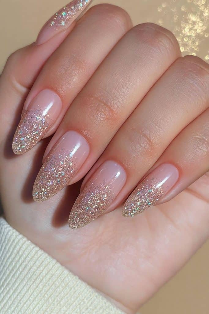 Sheer nude nails with delicate gold glitter sprinkles