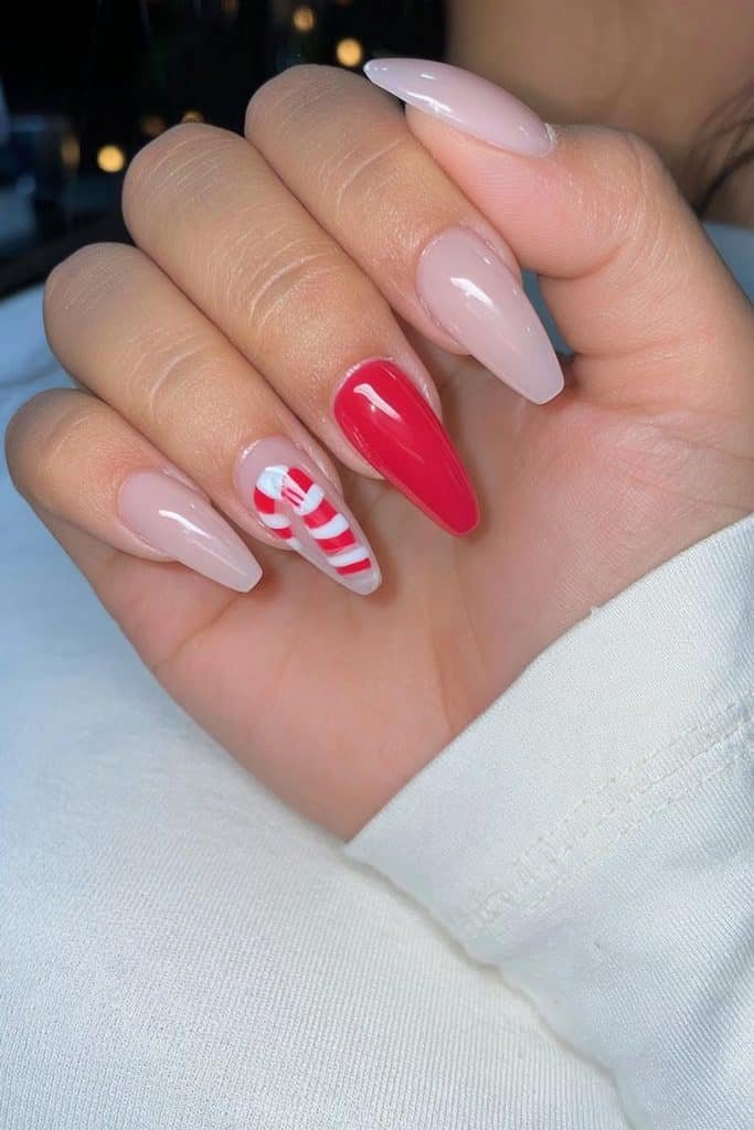 Milky nude nails with a single candy cane accent