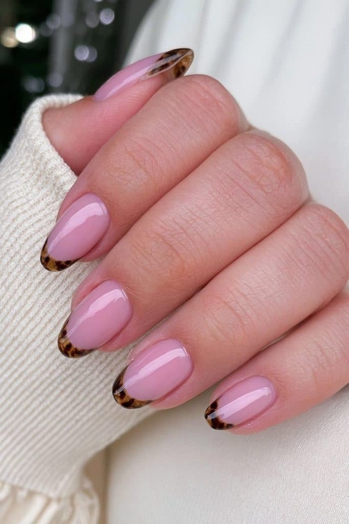 Sheer nude nails with amber tortoiseshell French tips