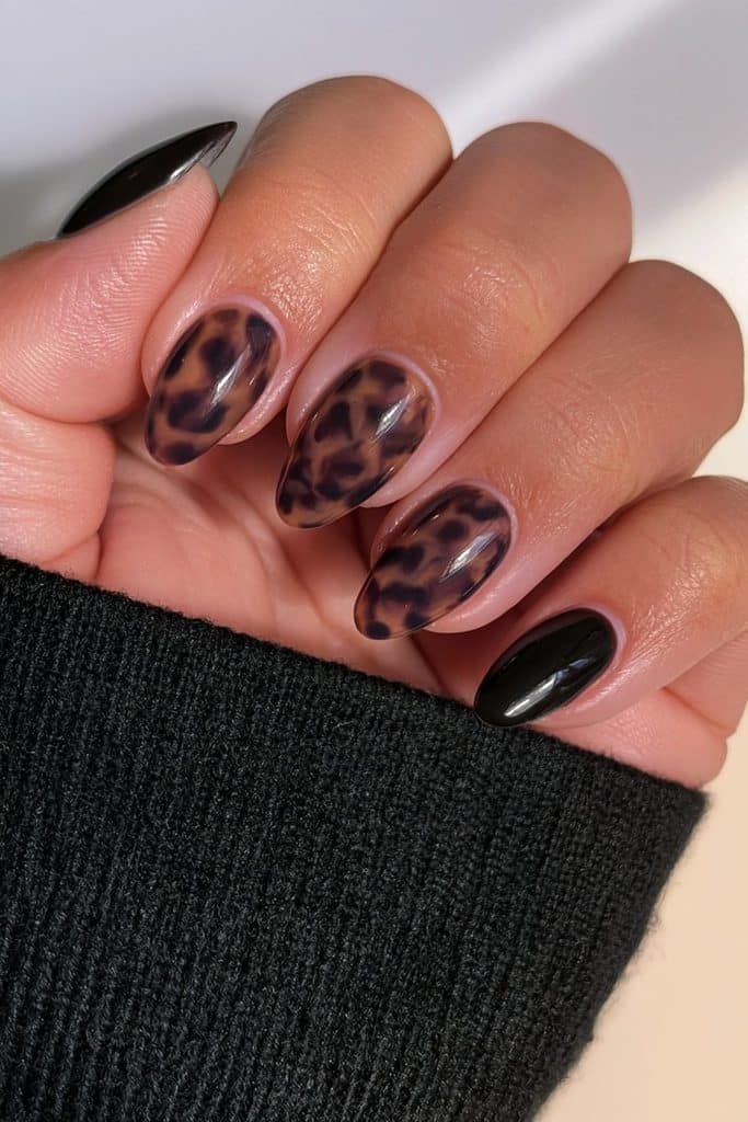 Amber tortoiseshell nails paired with glossy black accents