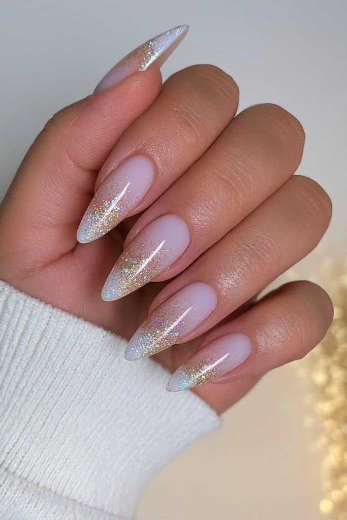 Milky white nails with delicate gold glitter accents