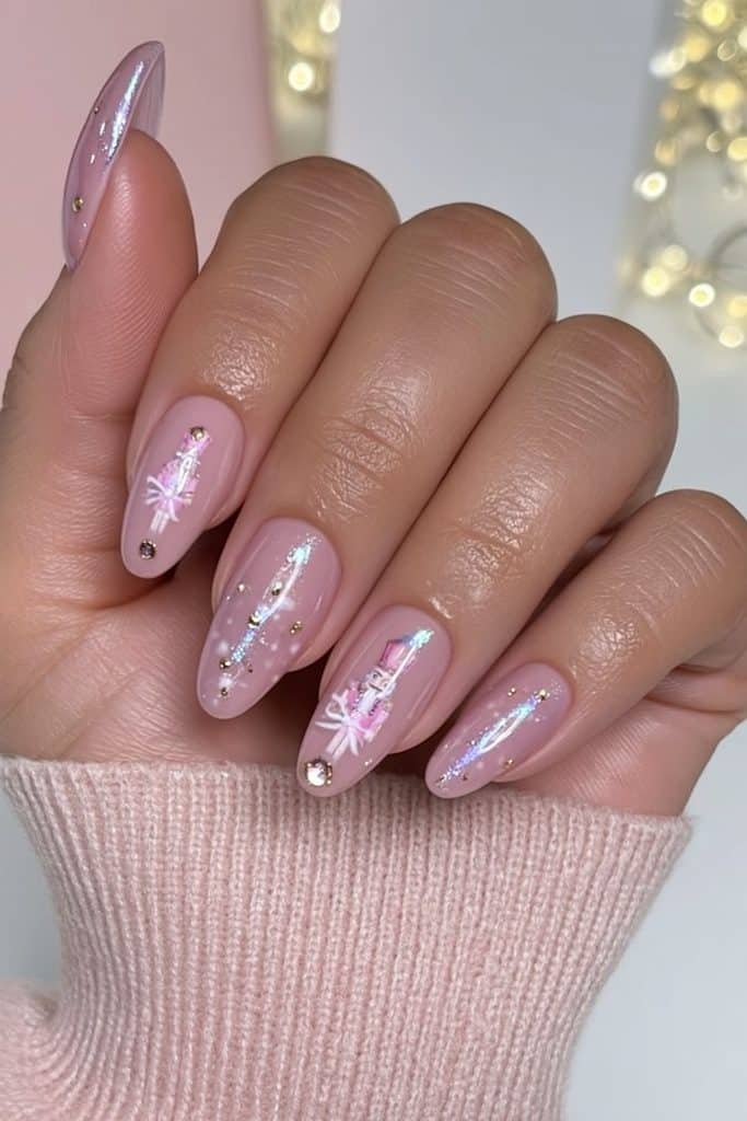 Ballet pink nutcracker nails with tiny gold buttons, white bows, and rose-gold accents