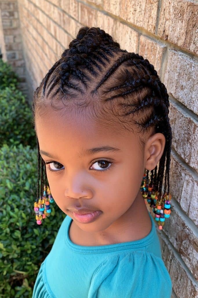 Kids mohawk-inspired cornrows with slim braided rows, a raised central section, and colorful beads.