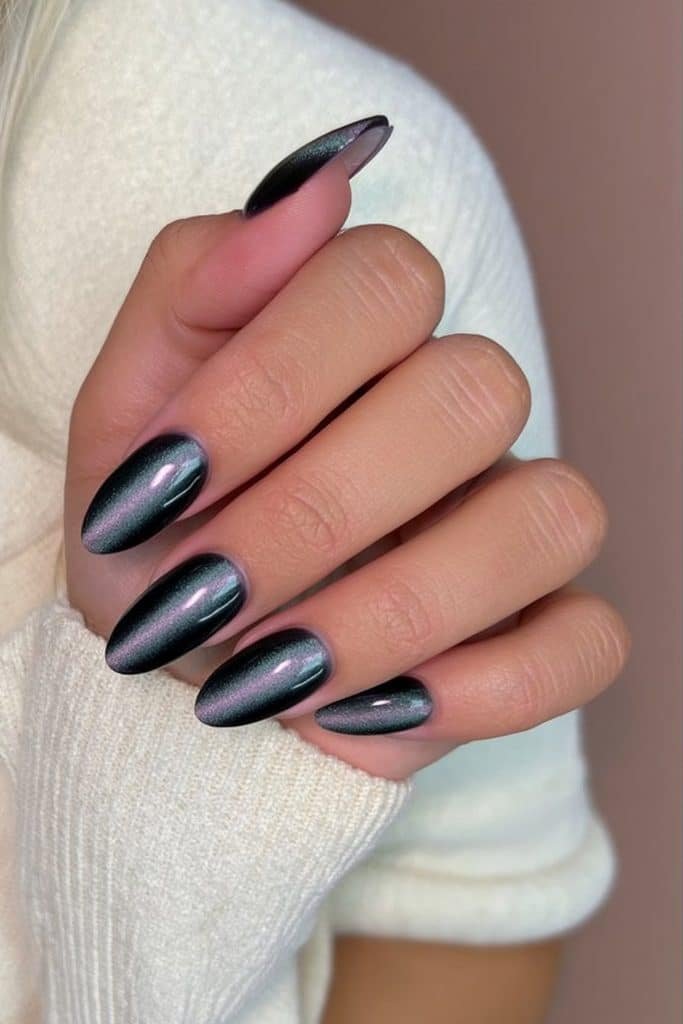 Black magnetic cat-eye nails with smoky silver reflections and subtle cat silhouettes