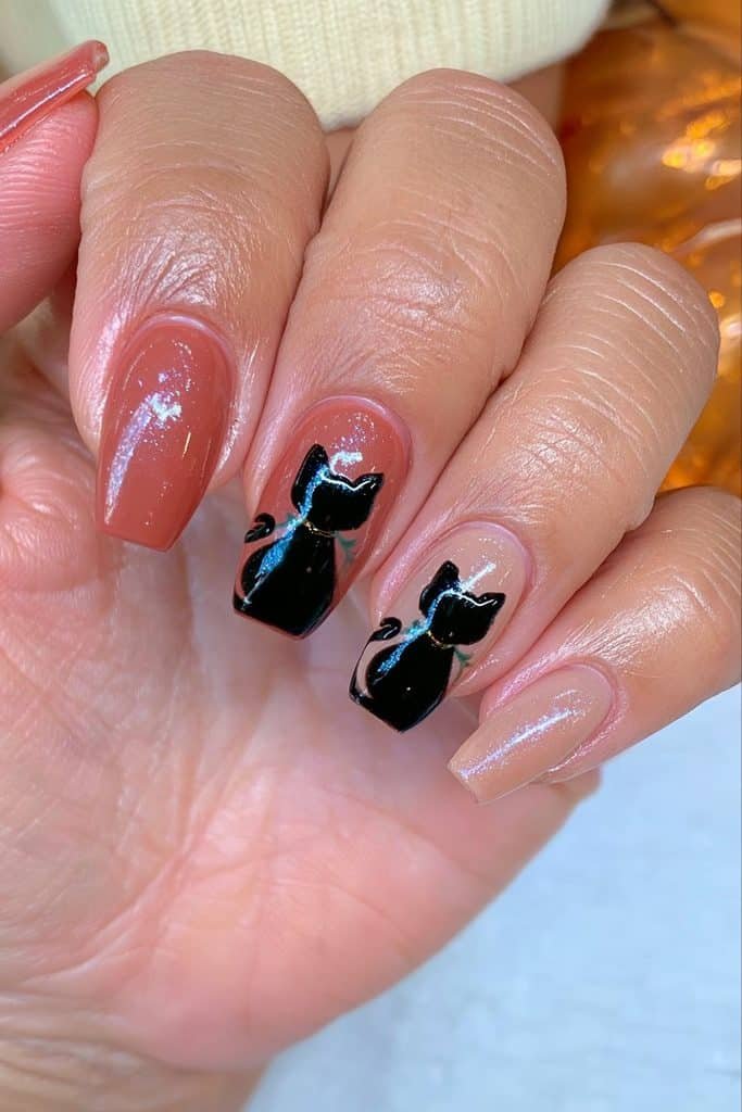Autumn black cat nails with tiny orange pumpkins, green stems, and gold accents