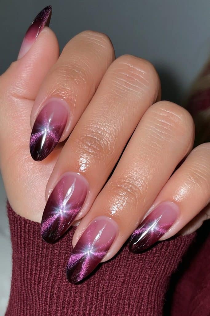 Black cherry purple cat-eye nails with wine-red undertones and luminous violet reflections
