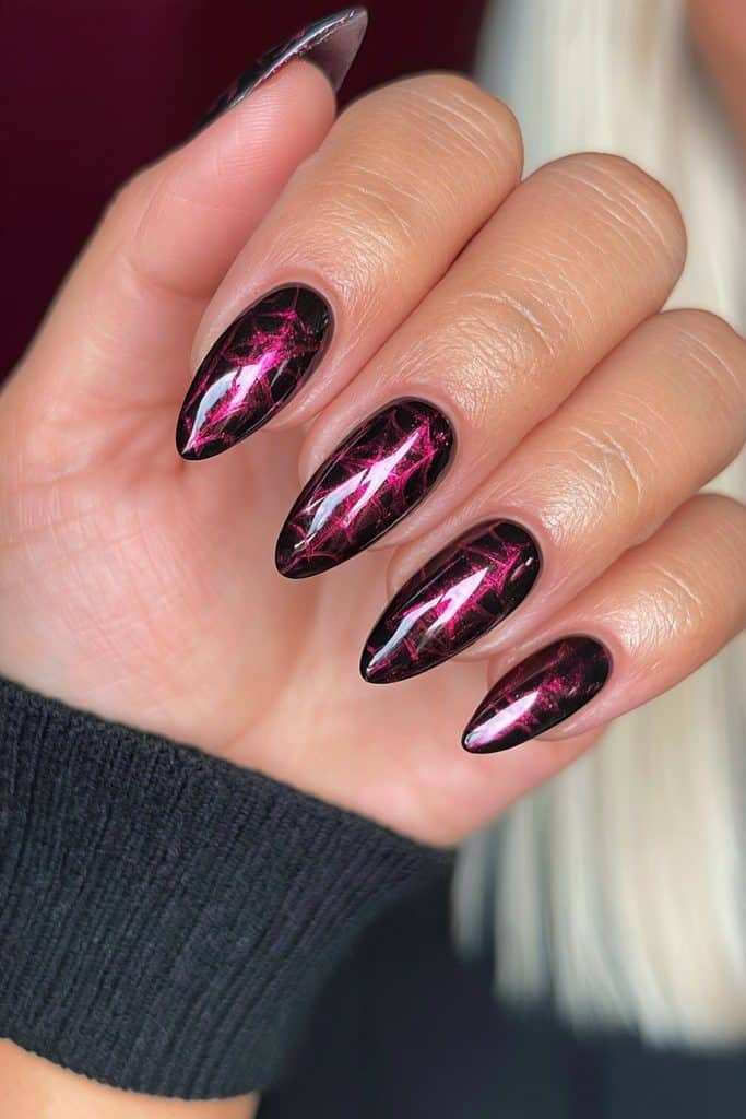 Black widow nails with deep black polish and dramatic crimson-red spider web accents