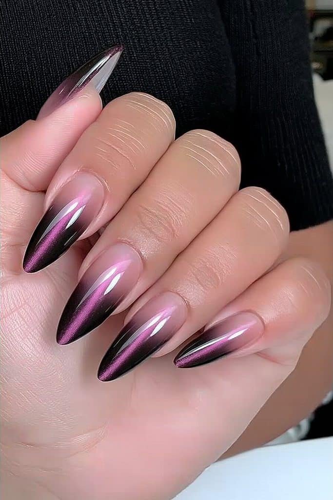 Blackened purple cat-eye nails with a near-black aubergine base and intense violet beams