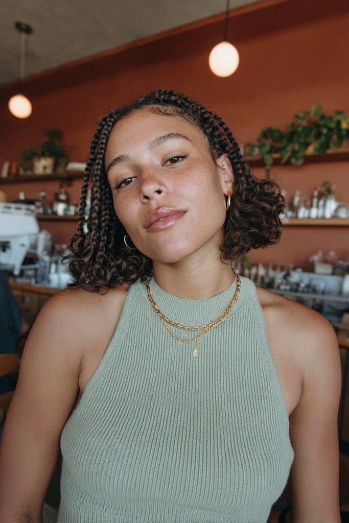 Boho bob knotless braids with chin-to-shoulder length plaits, playful loose curls, and a rounded silhouette.