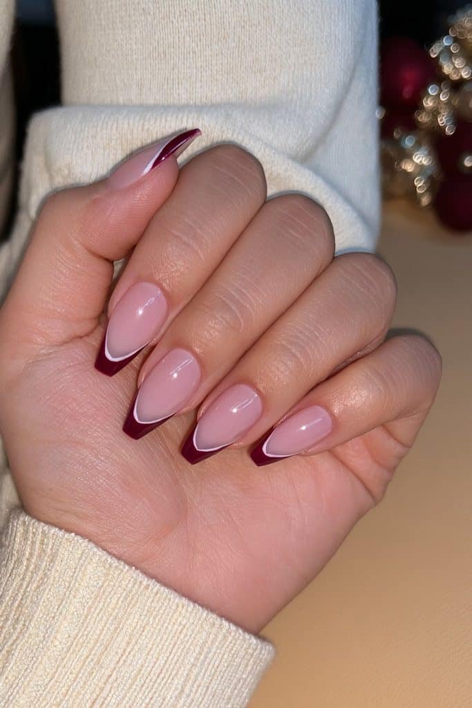 Milky nude nails with elegant deep burgundy French tips and glossy salon shine