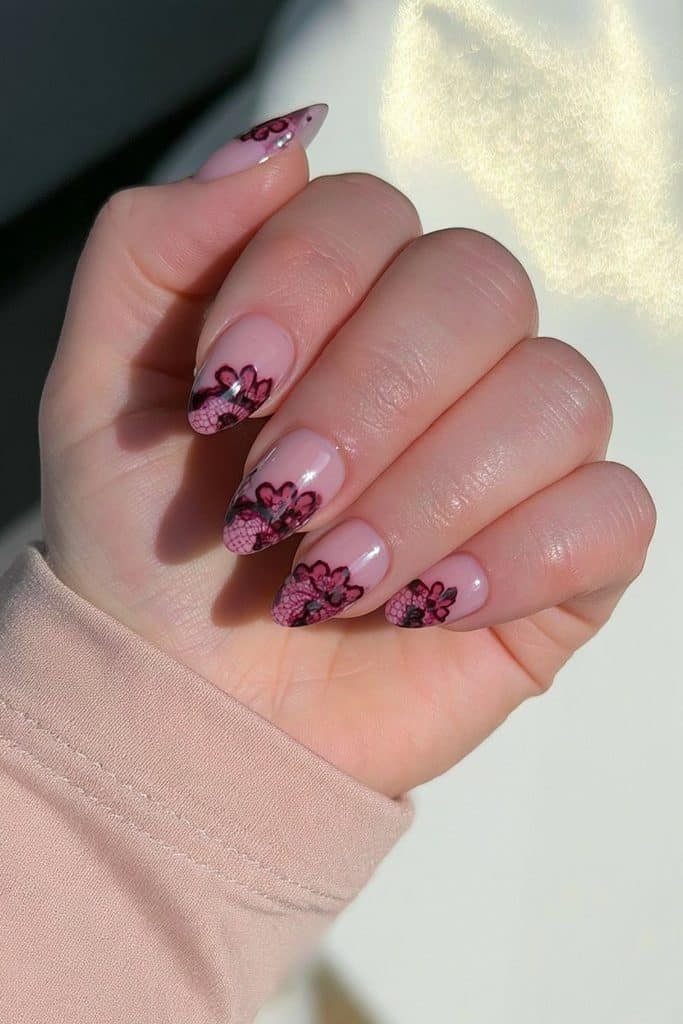 Burgundy lace nails with delicate wine-red floral linework over a sheer milky base