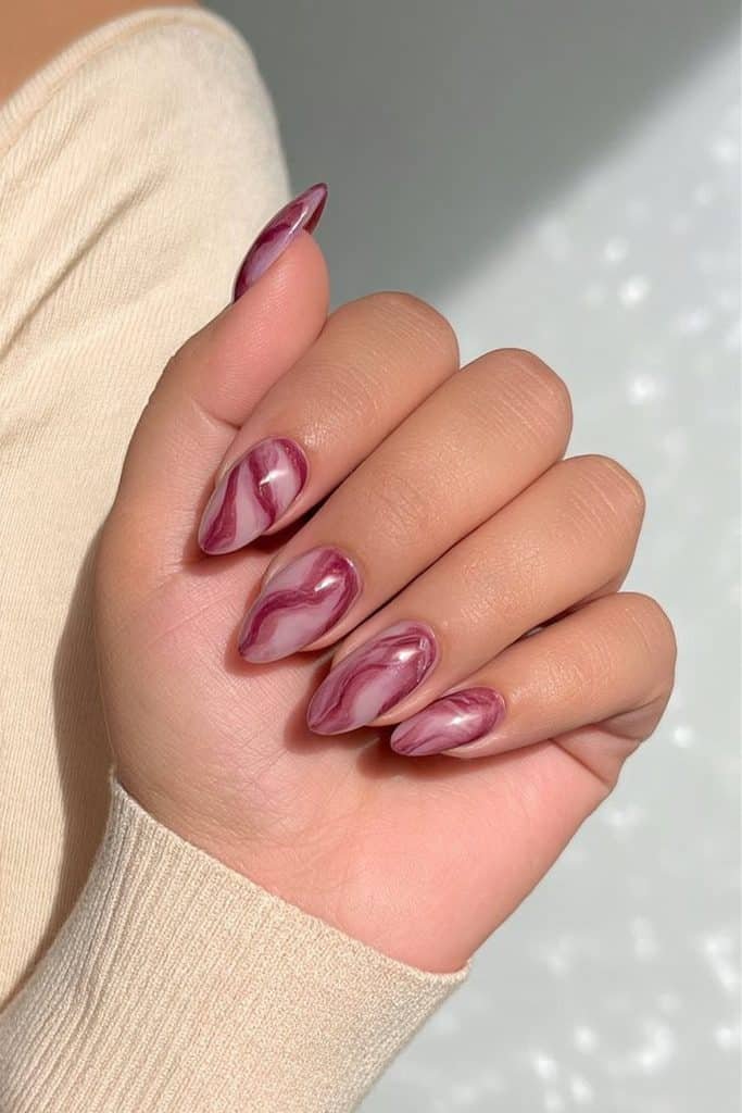 Burgundy marble nails with deep merlot veining over a sheer milky nude base