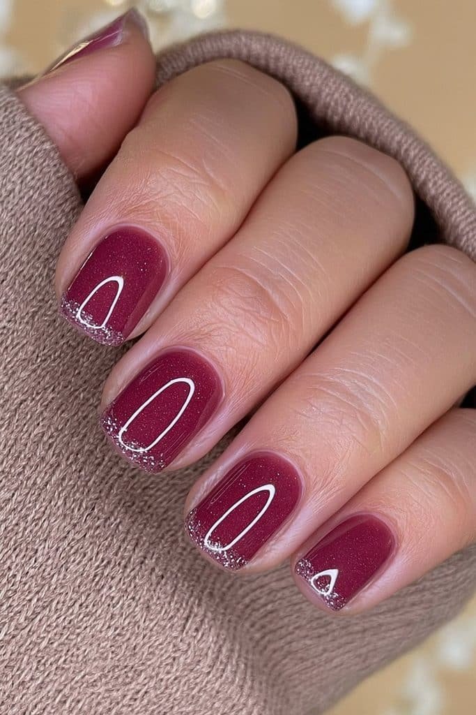 Short burgundy nails with classic wine-red polish and a simple glossy everyday finish
