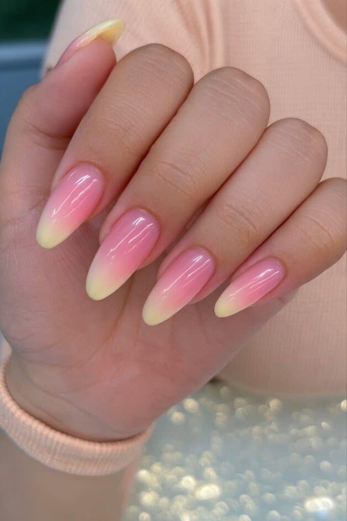 Butter yellow to blush pink ombré nails with a seamless pastel gradient and glossy finish