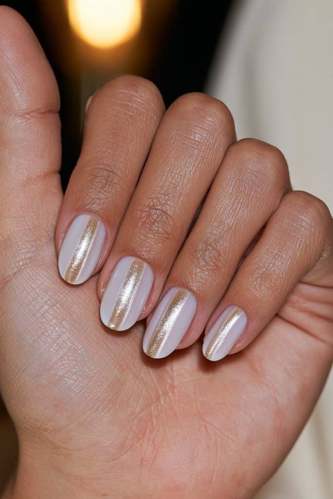 Champagne white cat eye nails with warm golden magnetic stripes and glossy ivory polish