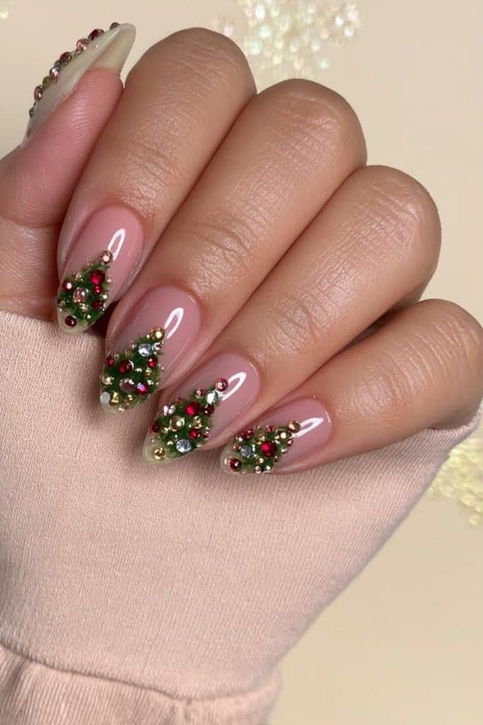 Forest-green Christmas tree nails decorated with tiny red, clear, and gold rhinestones