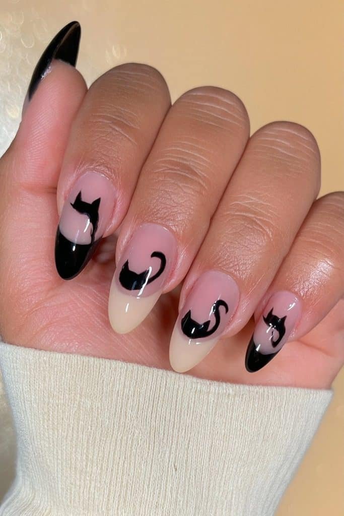 Glossy black cat silhouette nails with pointed ears, curved backs, and graceful tails