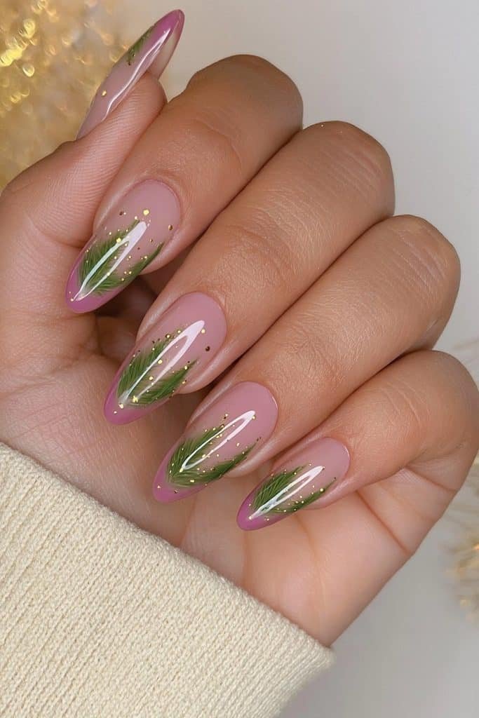 Classic forest-green Christmas tree nail art on sheer nude almond nails with tiny gold dots