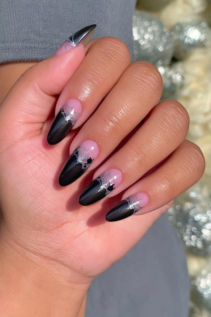 Glossy black cat nails with delicate silver-gray cobwebs and tiny cat silhouettes