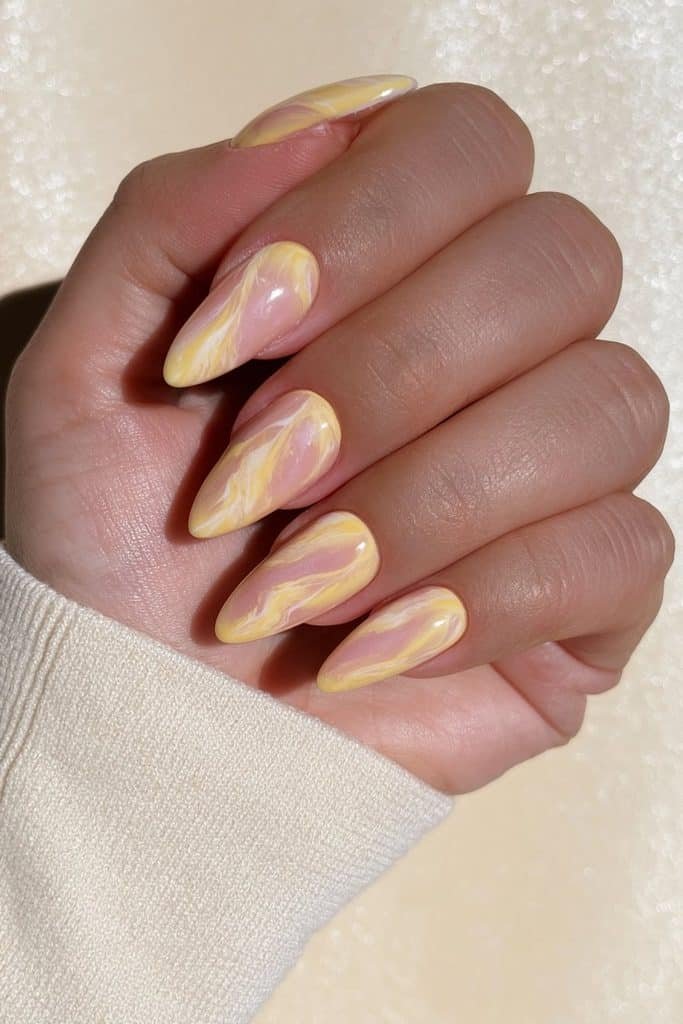 Butter yellow and creamy white marble nails with delicate flowing ivory veins