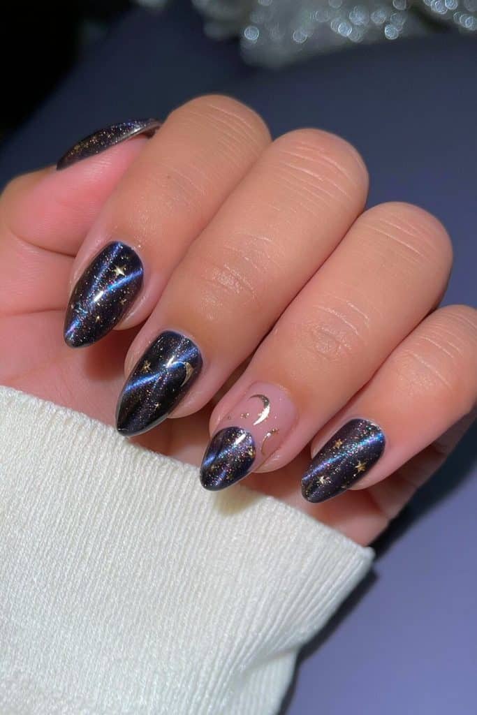 Midnight navy cat-eye nails with sapphire light trails, delicate silver crescent moons, and tiny stars