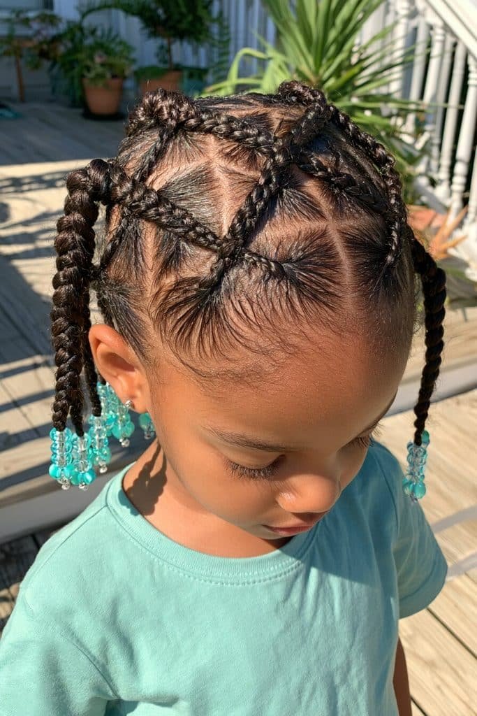 Kids criss-cross braids with an intricate geometric pattern, neat scalp parts, and turquoise and clear beads.