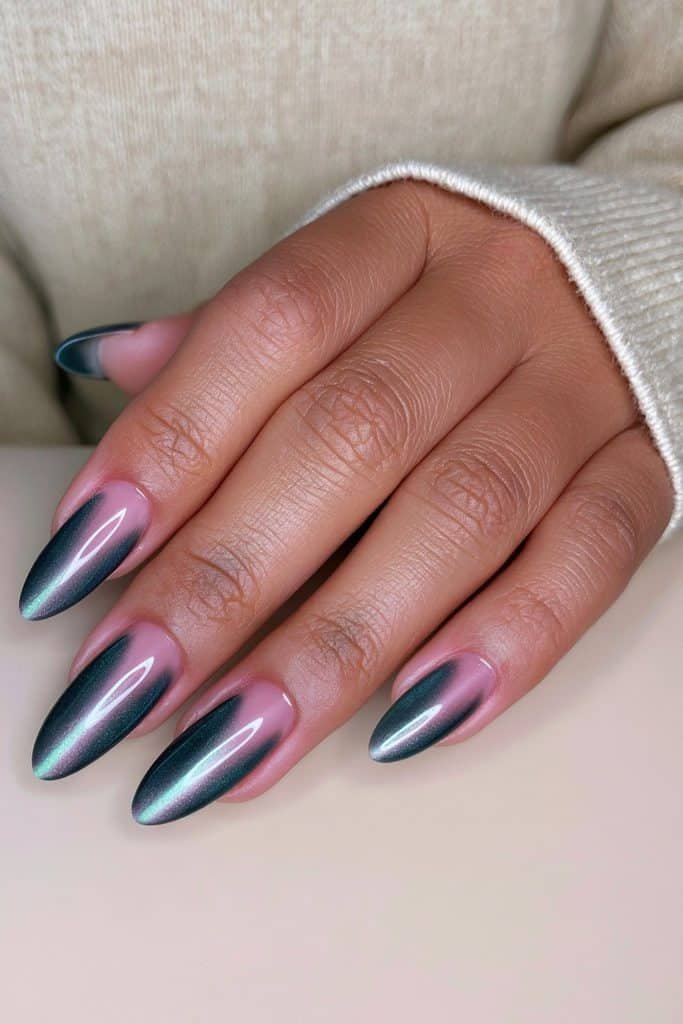 Medium almond-shaped dark green cat eye nails with a long, luminous emerald shimmer line.