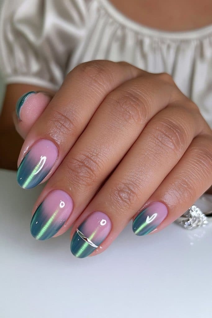 Dark green cat eye nails with delicate silver chrome lines and a tiny metallic crescent accent.