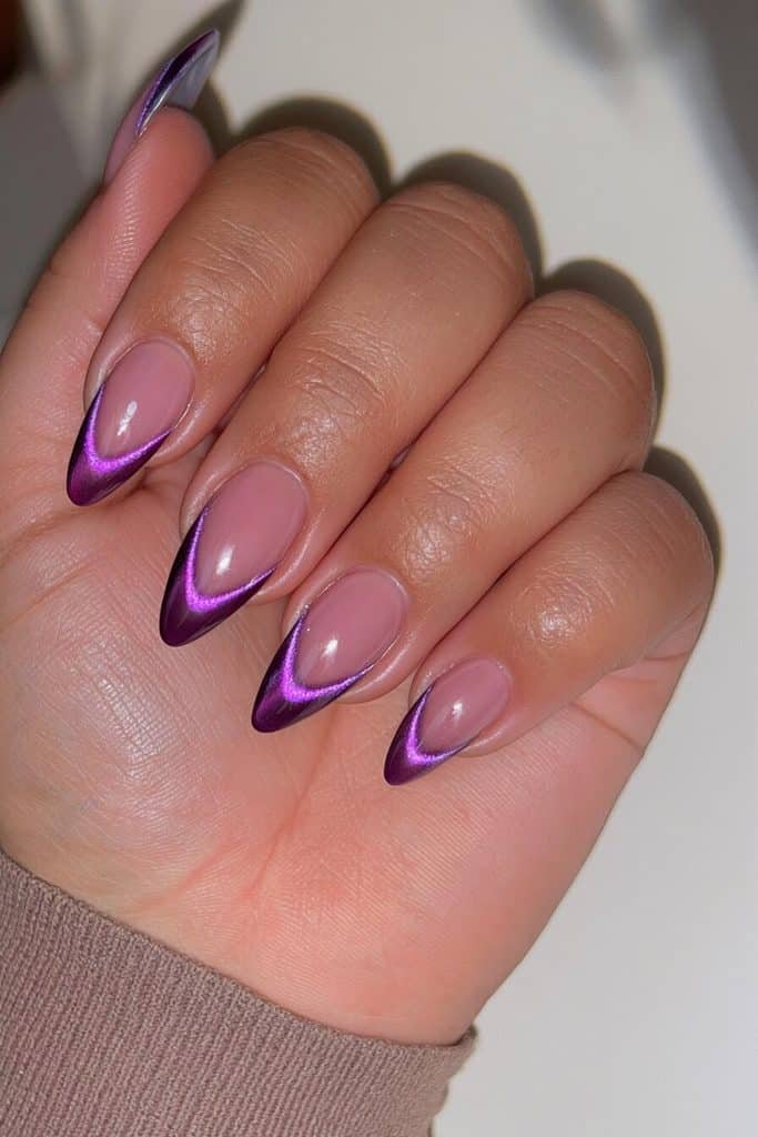 Dark purple cat-eye French tip nails with sheer pink bases and luminous violet tips