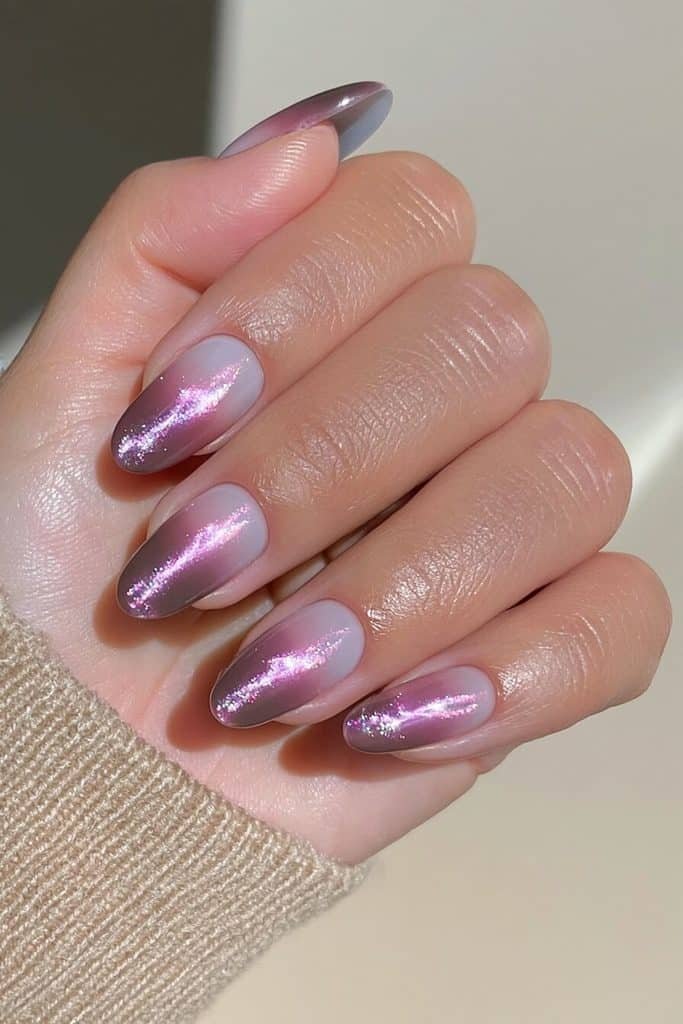 Dark purple cat-eye nails paired with rich mocha-brown accents and a delicate swirl