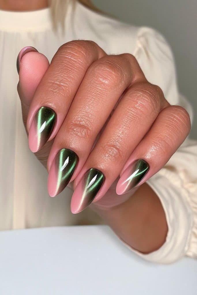 Dark green cat eye almond nails featuring a diagonal emerald magnetic stripe for an elegant elongated look.