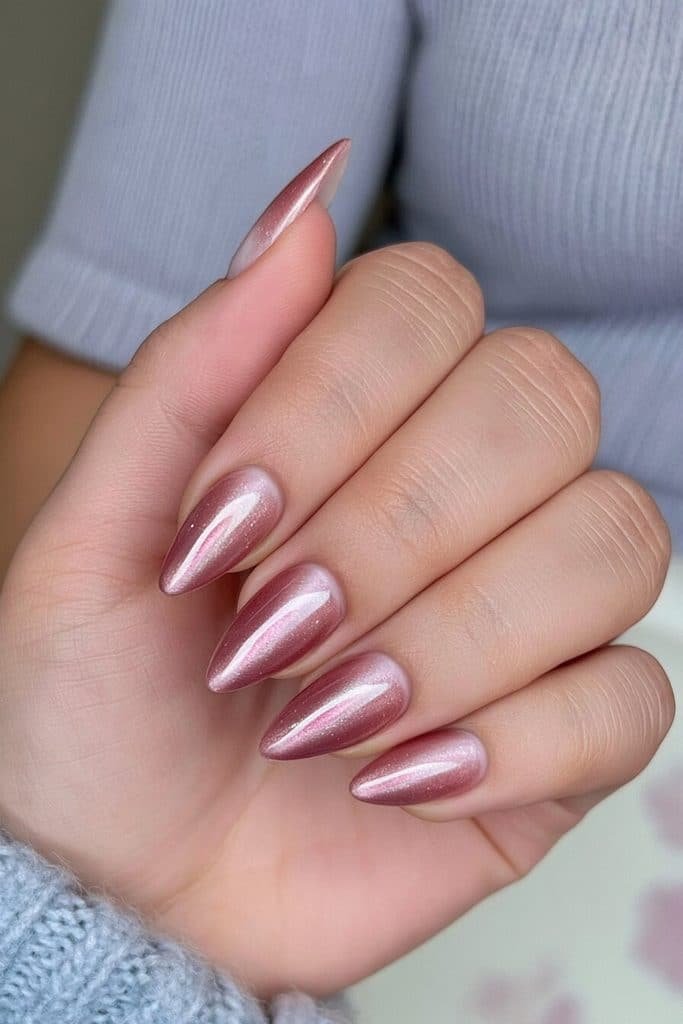 Dusty rose cat-eye nails with muted vintage pink tones and subtle smoky magnetic streaks