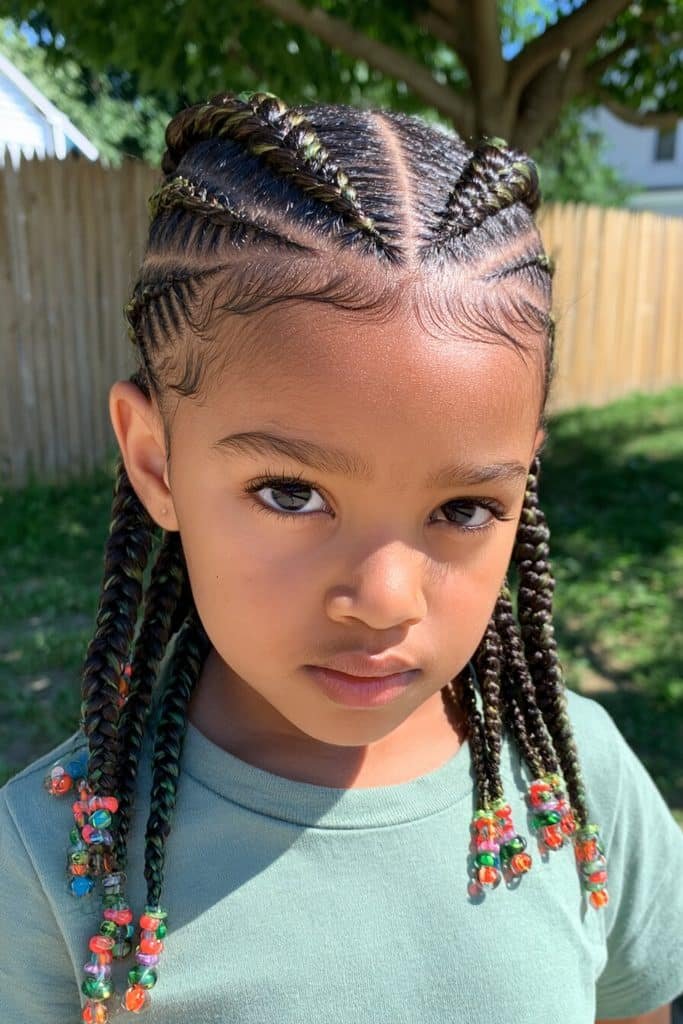 Kids feed-in braids with gradually thickening cornrows, evenly spaced sections, and colorful beaded ends.
