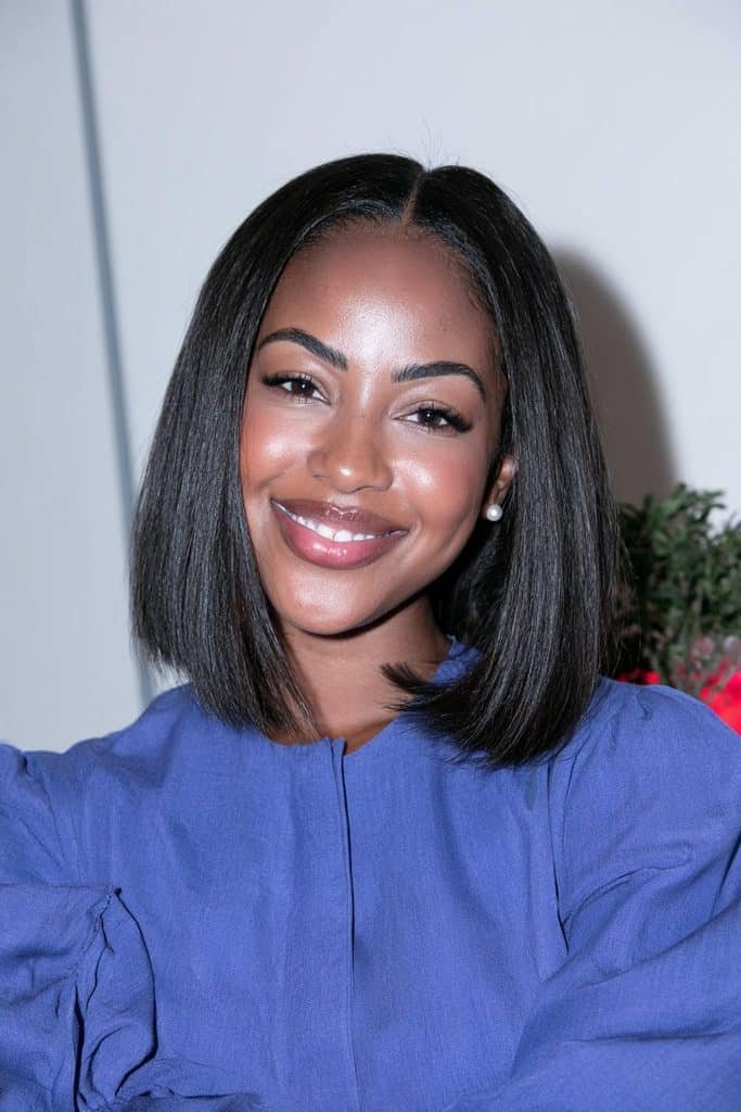 Black woman with a flipped bob for thin or fine hair, featuring a lightweight, softly voluminous shape and outward-flipped ends that create the appearance of fuller hair.