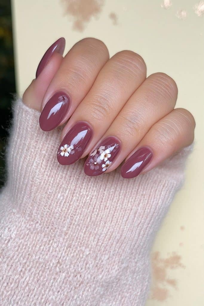 Floral mocha nails with creamy brown polish and tiny ivory and caramel flowers